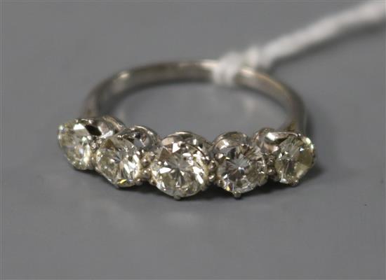 A mid 20th century platinum? and graduated five stone diamond ring, size M.